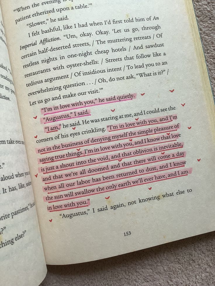 an open book with pink writing on the page and red marker in it's center