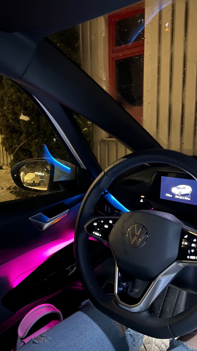 the interior of a car with purple lights