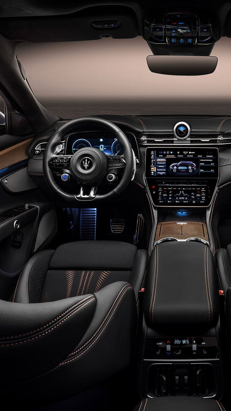 the interior of a car with black leather and tan trims, including steering wheel