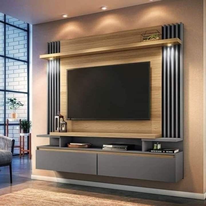 a living room with a large television on the wall