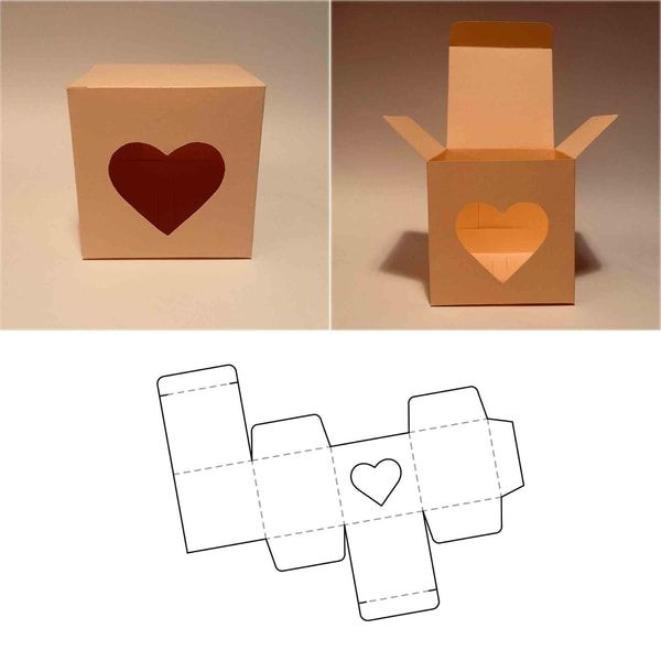 an open cardboard box with a heart cut out of the front and side, sitting on a white surface