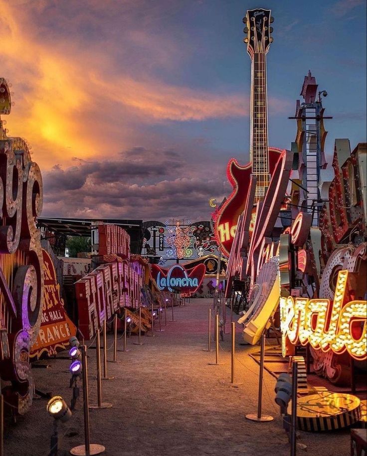 an assortment of neon signs and guitars on display