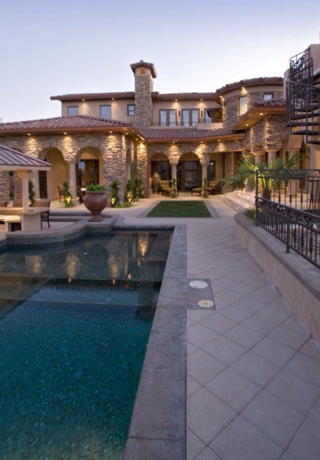 a large house with a swimming pool in front of it