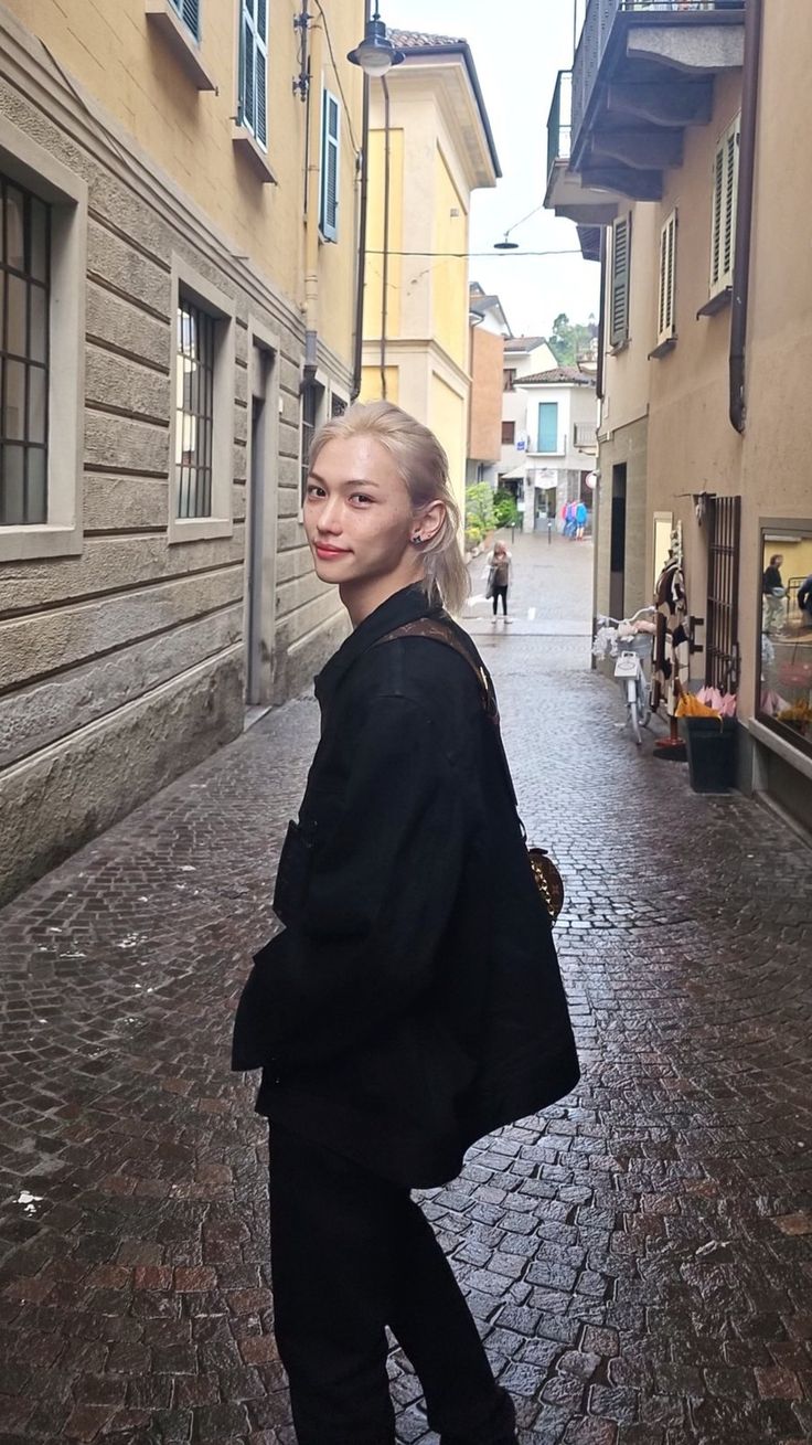 a woman is standing in an alley way