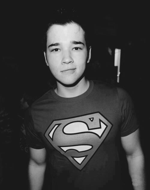 a young man wearing a superman t - shirt