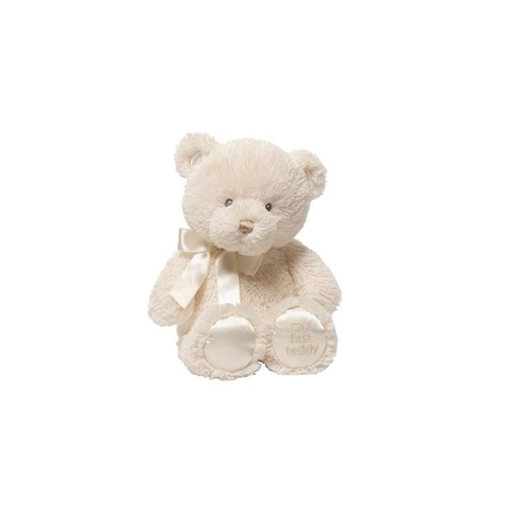 a white teddy bear with a bow on it's neck sitting in front of a white background