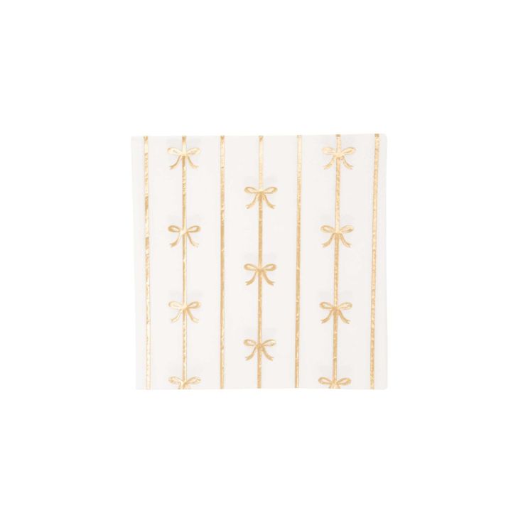 a white and gold napkin with bows on it