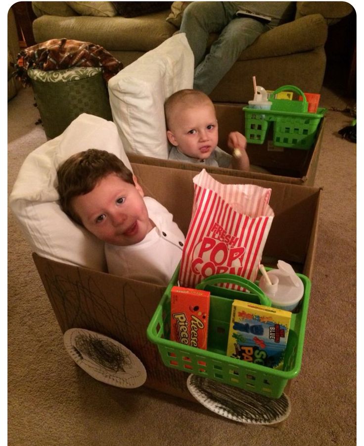 two young boys in boxes with books and toys