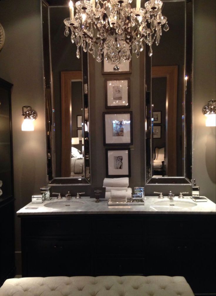 a bathroom with two sinks and a chandelier in the middle of the room