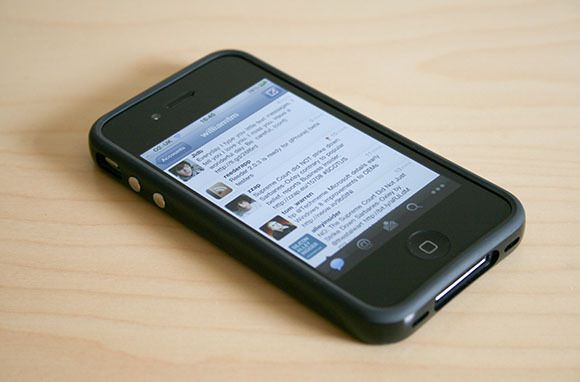 an iphone sitting on top of a wooden table