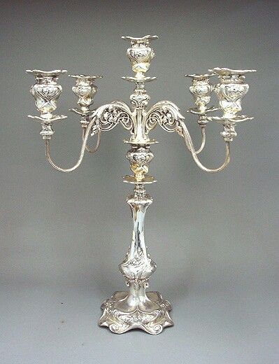 an ornate silver candelabra with five candles