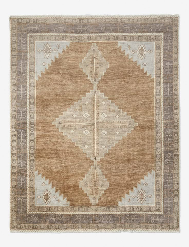 an antique rug with brown and beige colors