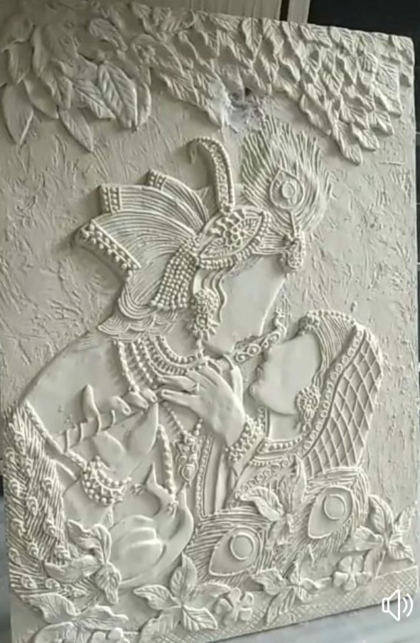 an intricately carved white wall panel with flowers and birds on the side, in front of