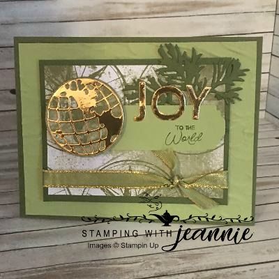 a close up of a card with the word joy on it and a gold globe