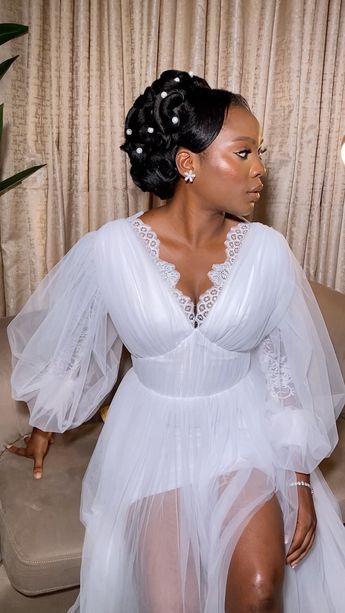 a woman sitting on top of a couch wearing a white dress