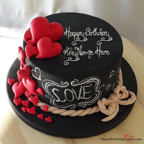 a black cake with red hearts and writing on it