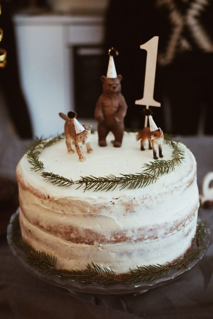 a birthday cake with frosting and animals on top