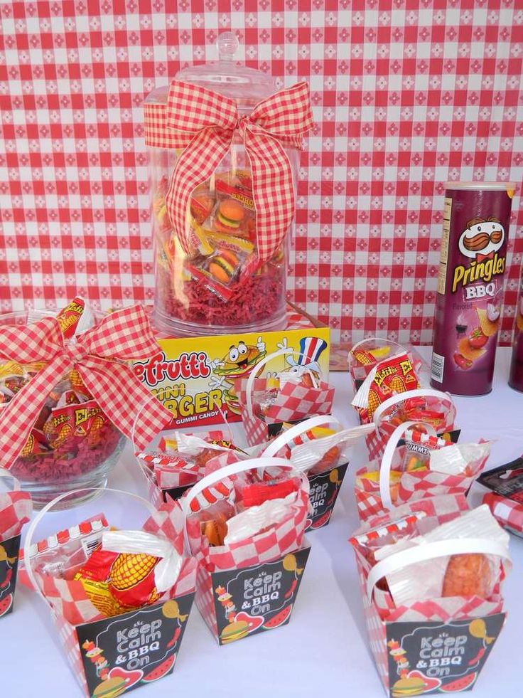 some candy and candies are on a table with red gingham checkered cloth