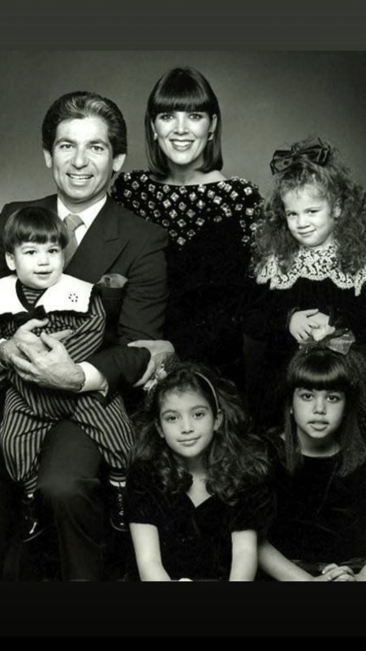 a family posing for a black and white photo