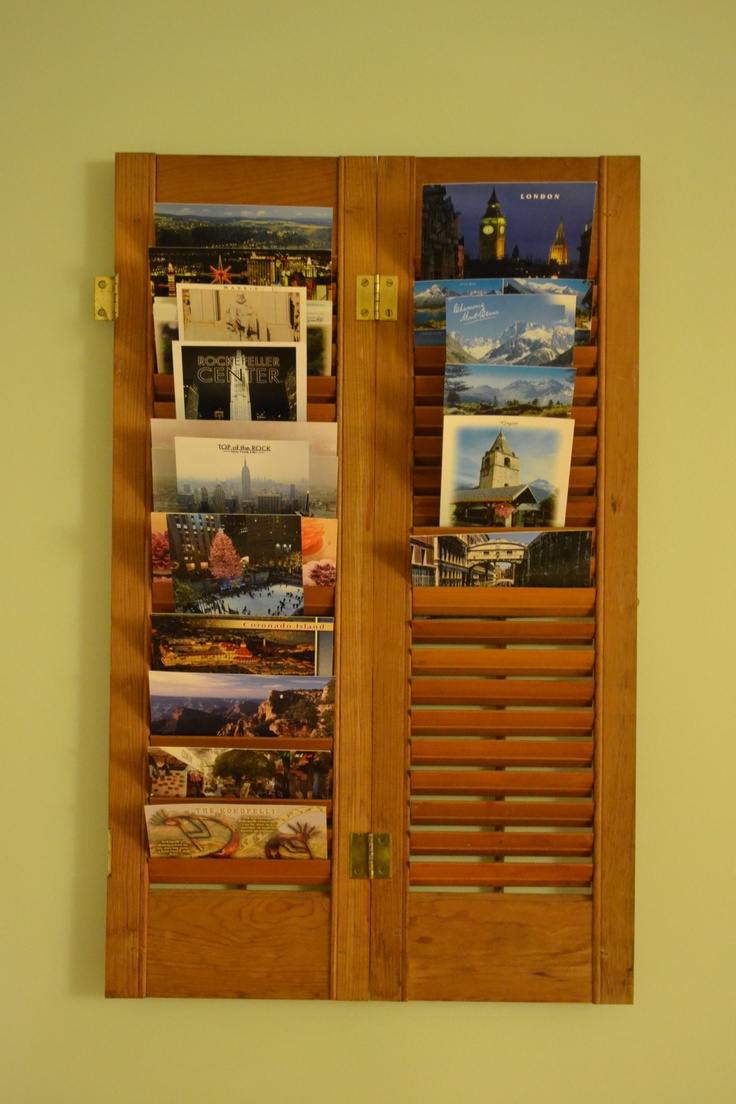 two wooden doors with shutters open and pictures on them