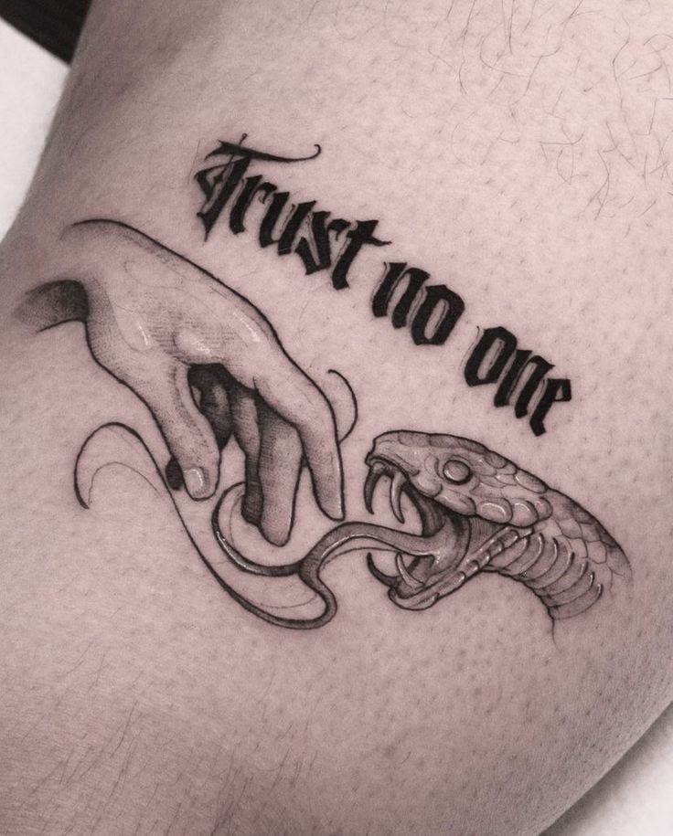 a close up of a person's thigh with a tattoo on it that says trust no one