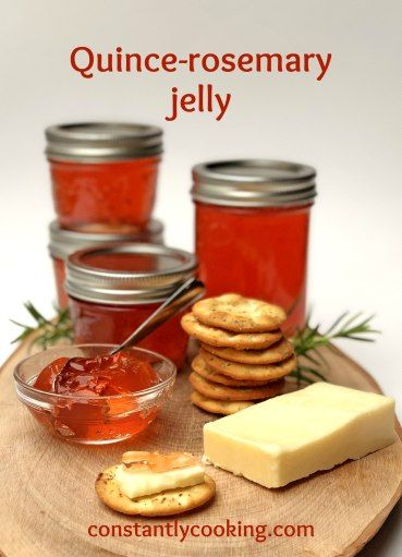 there are jelly and crackers on the table with jams in glass jars next to them