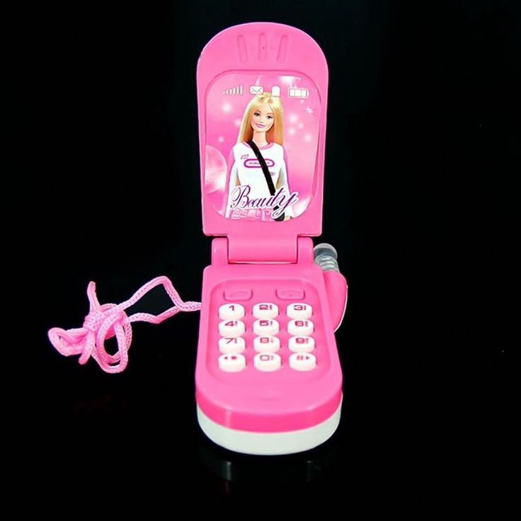 a pink cell phone with a barbie doll on it's display case and cord