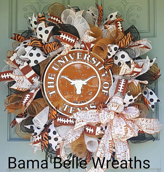 the university of texas football wreath is decorated with orange, white and black paper streamers