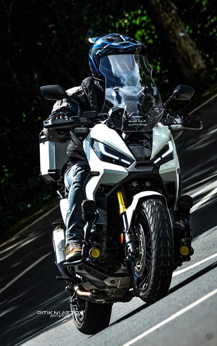 a man riding on the back of a white motorcycle