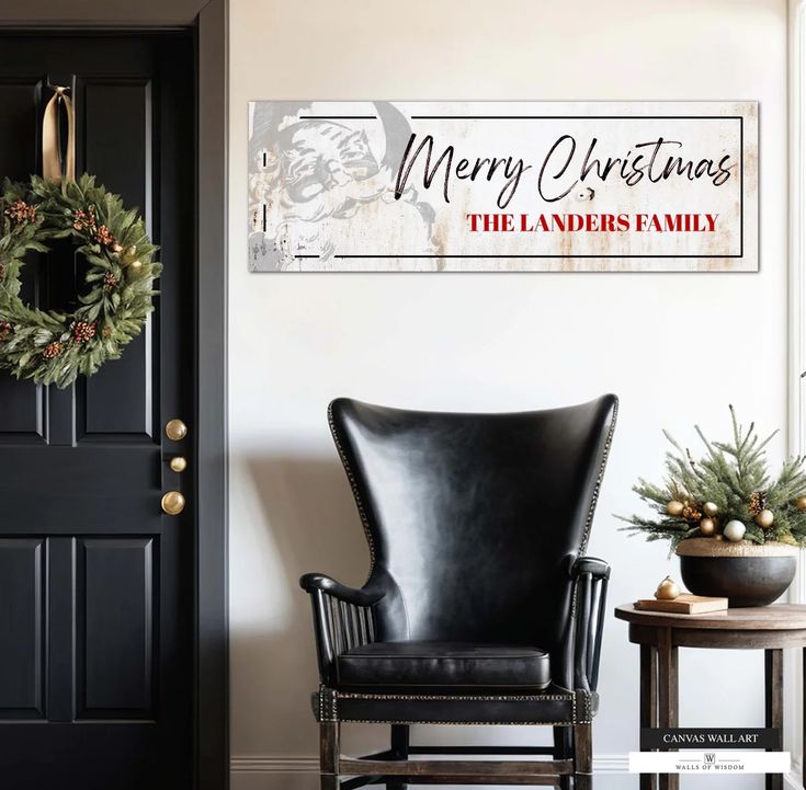 a black leather chair sitting in front of a christmas sign on the wall next to a door