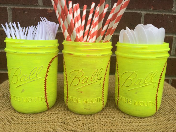 three mason jars with straws in them sitting on a table