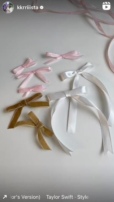 several pieces of paper with bows and ribbons on them, all in different shapes and sizes