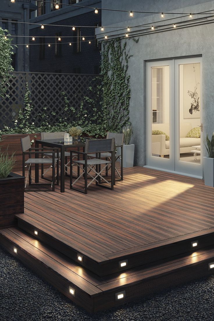 an outdoor deck lit up with lights