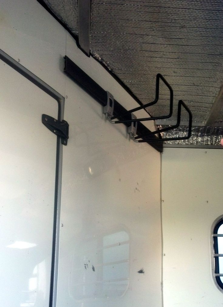 the inside of a white trailer with metal bars