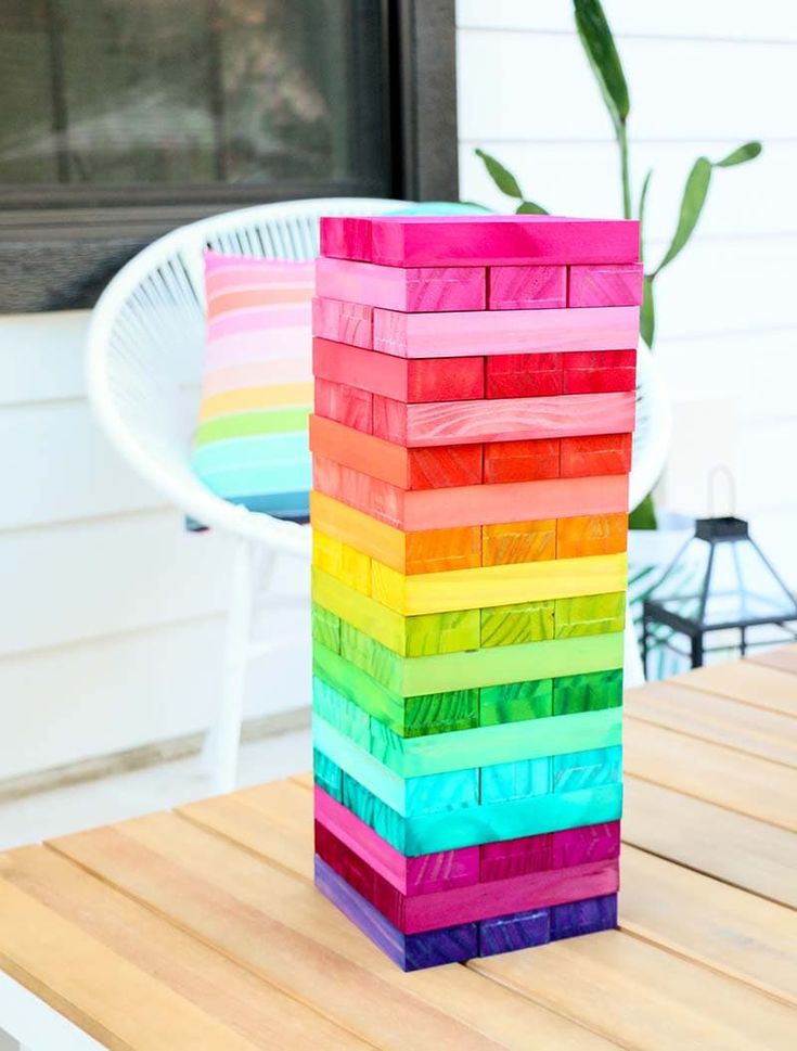 a stack of colored blocks sitting on top of a wooden table