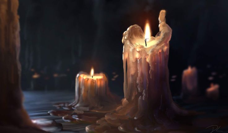 three lit candles sitting on top of a table