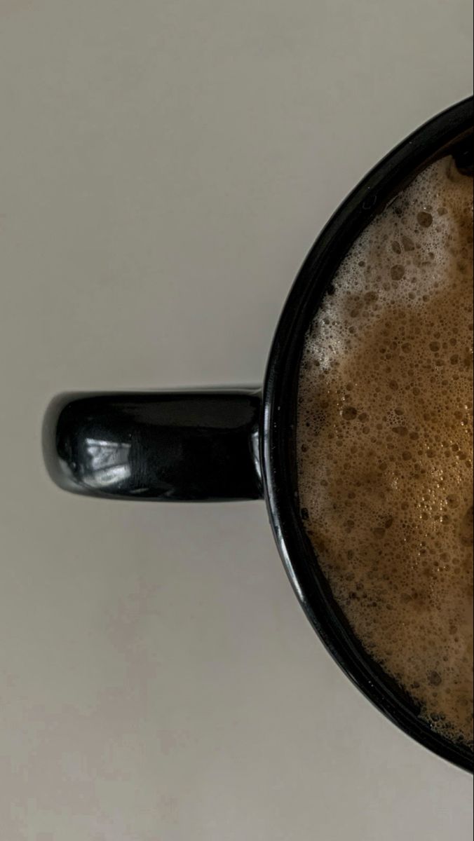 a mug filled with liquid sitting on top of a table