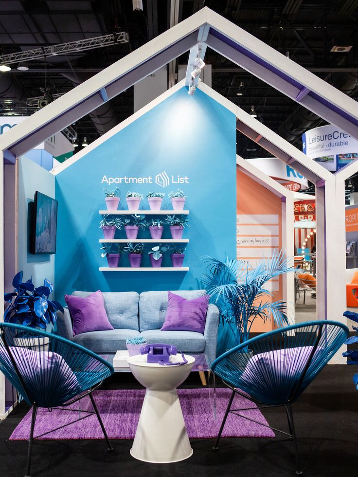 a blue and white booth with purple accents