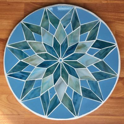 a blue and white plate sitting on top of a wooden floor