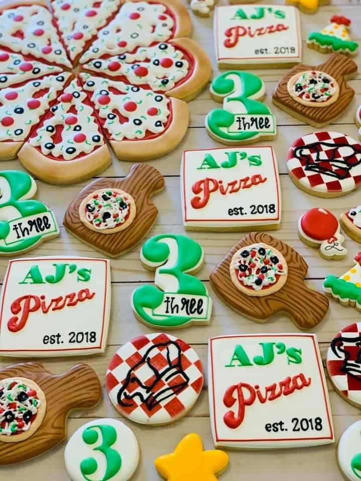 decorated cookies are arranged on a table for an event to be attended by children and adults