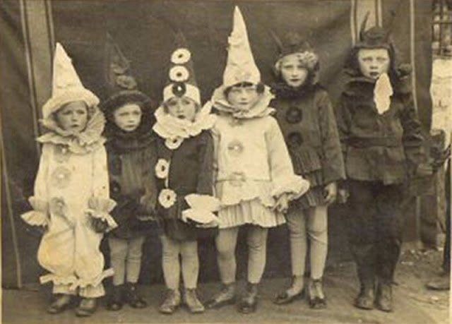 an old black and white photo of children dressed in costumes