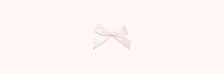 a white bow on top of a light pink background with the word hello kitty written below it