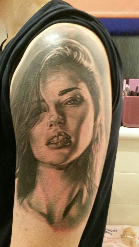 a woman's face is shown on the back of her arm, and it appears to be in black and white