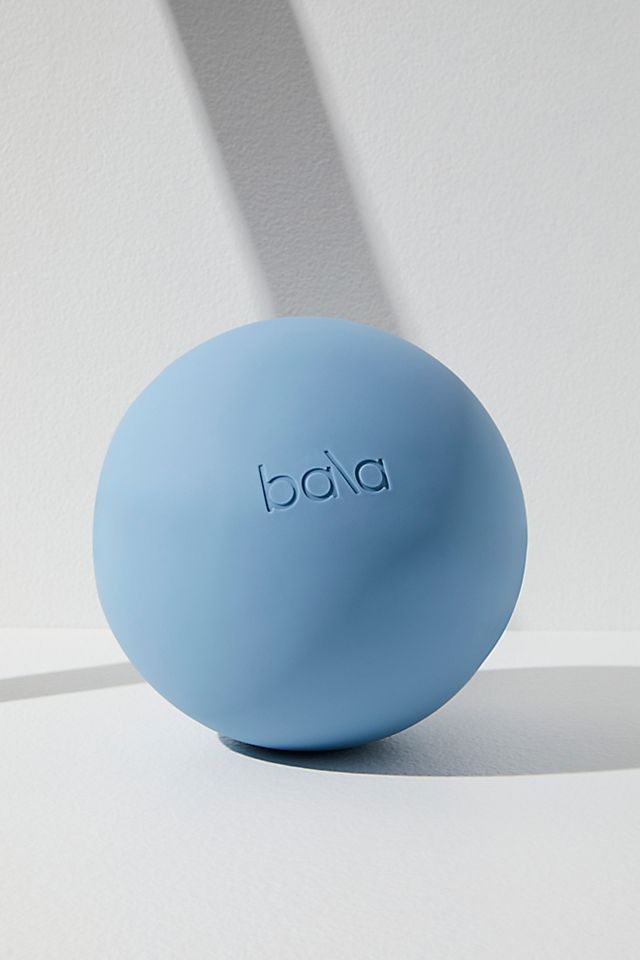 a blue soap ball sitting on top of a white counter next to a shadow from the wall