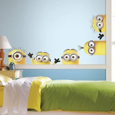 a bed room with a neatly made bed and three minion stickers on the wall