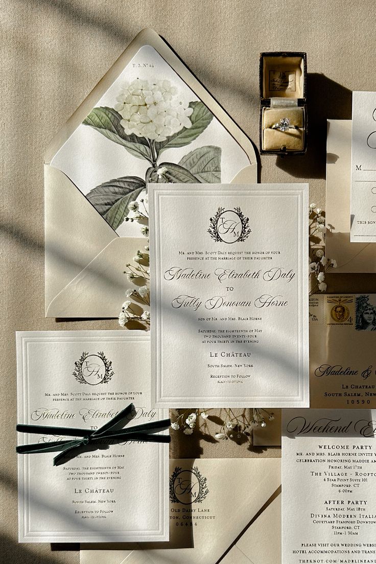 the wedding stationery is laid out on top of an envelope and other items for guests to use