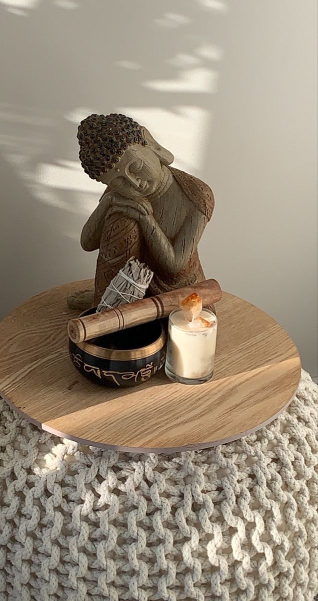 a small statue sitting on top of a wooden table