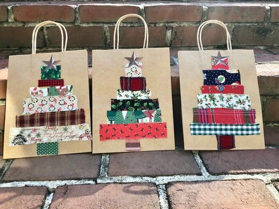 three brown bags with christmas trees on them