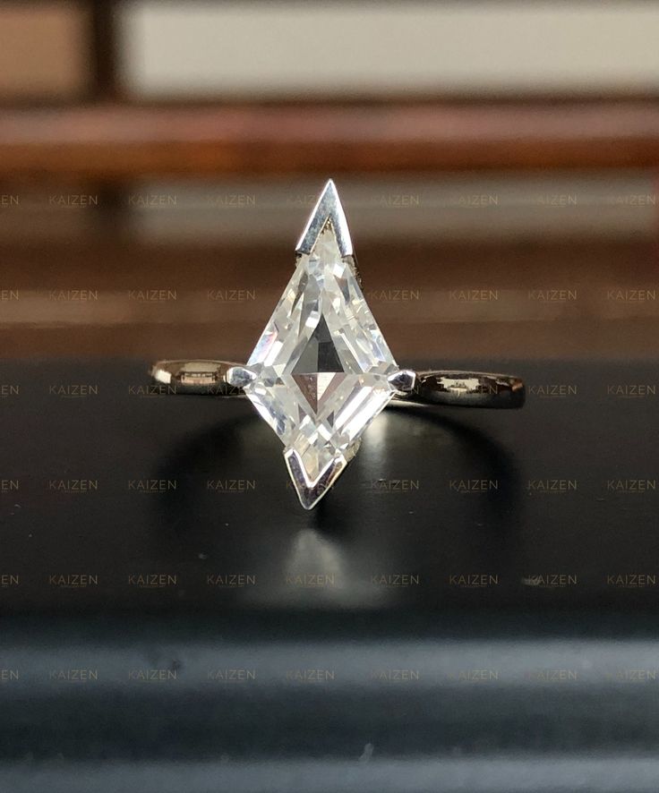 a diamond ring sitting on top of a table