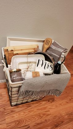 a basket filled with kitchen items on top of a hard wood floor